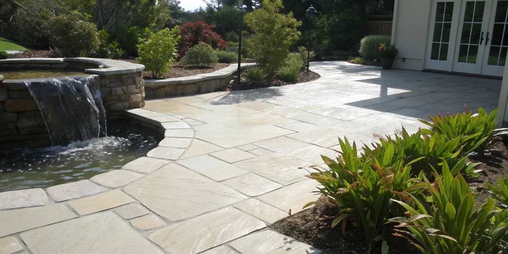 A backyard paver patio after a thorough cleaning and sealing process.