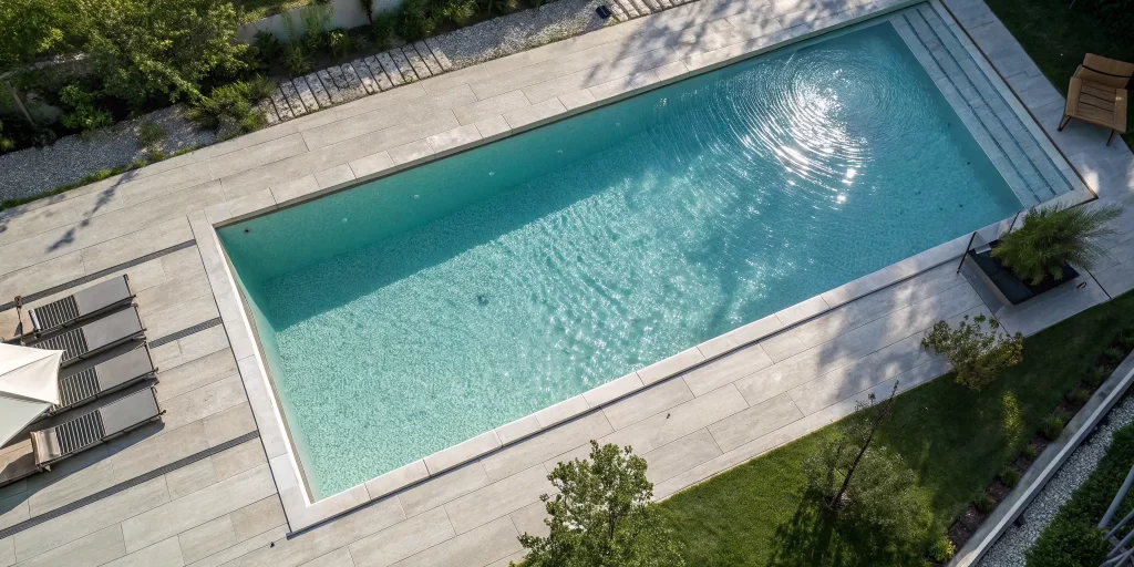 A remodeled pool deck using the best pavers for a modern and safe swimming area.